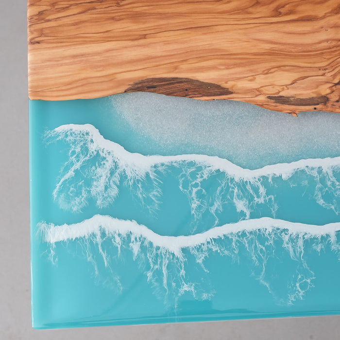 Wooden surface with a blue resin and wave design