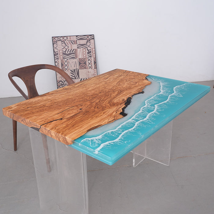 Table with wooden top and blue resin finish, accompanied by a chair.