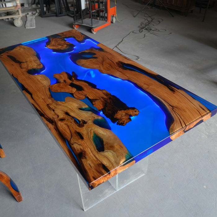 Wooden table with blue resin inlay in a workshop setting
