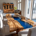 Dining room with a unique wooden table featuring a blue resin inlay.