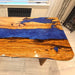 Custom handmade olive wood blue epoxy river table crafted by skilled artisans in California.