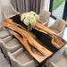 Custom artisan olive wood table with resin elements showcasing natural wood patterns.