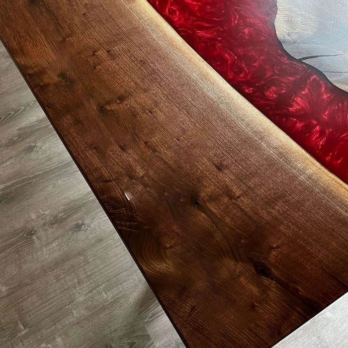Wooden bench with a red cushion on a gray floor