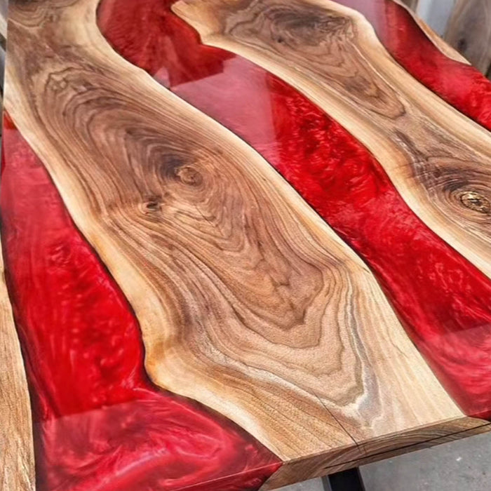 Custom red resin and walnut slab table for luxury dining rooms