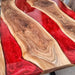 Custom red resin and walnut slab table for luxury dining rooms