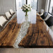 Bespoke walnut and clear resin dining table in a bright, modern interior setting.