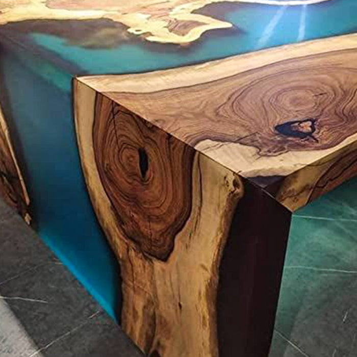 Wooden table with blue resin finish on a gray surface