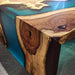 Wooden table with blue resin finish on a gray surface