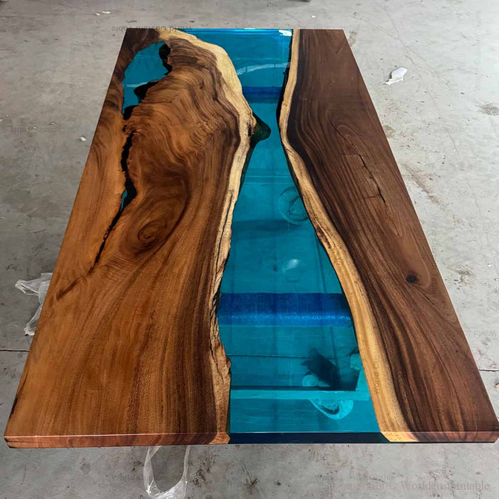 Wooden table with blue resin inlay on a concrete floor