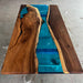 Wooden table with blue resin inlay on a concrete floor