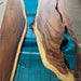 Wooden table with blue resin inlay on a concrete floor