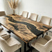 Custom walnut table with natural live edge detail and deep black epoxy river design.