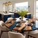 Custom walnut and resin dining table featuring a smoky black epoxy river for luxury homes.