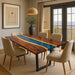 Dining room with a wooden table featuring a blue resin inlay, surrounded by beige chairs.