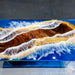 Epoxy resin table with wood and glass design on a dark background