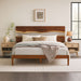 Wooden bed with matching headboard in a bedroom setting