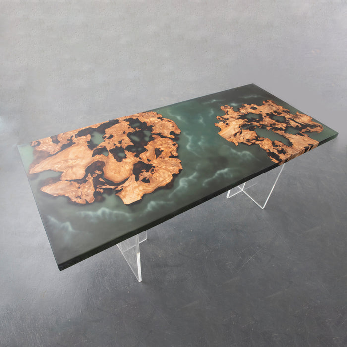 A burl, a ripple of resin, where time and craftsmanship meet. It’s as if a piece of nature was captured in a tabletop — and when you sit here, you can almost hear the waves whisper through the trees.