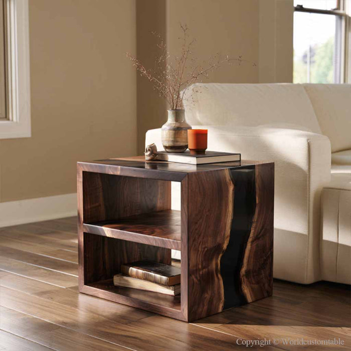 Two tier epoxy sofa table with black resin, walnut wood, books, and decorative accessories on the lower shelf