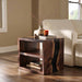 Two tier epoxy sofa table with black resin, walnut wood, books, and decorative accessories on the lower shelf