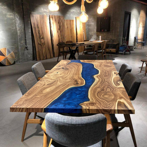 Dark blue epoxy resin dining table with natural elm wood grain and live edge design, perfect for modern dining rooms.