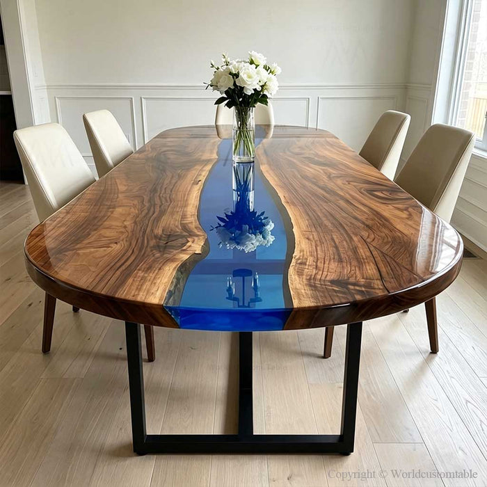 Close up view of a custom-designed oval conference table featuring an intricate deep blue vortex epoxy river and rich walnut grain, ideal for modern collaborative meeting spaces.