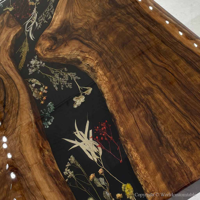 Designer dining table made of black walnut and floral epoxy resin highlighting handcrafted furniture detail