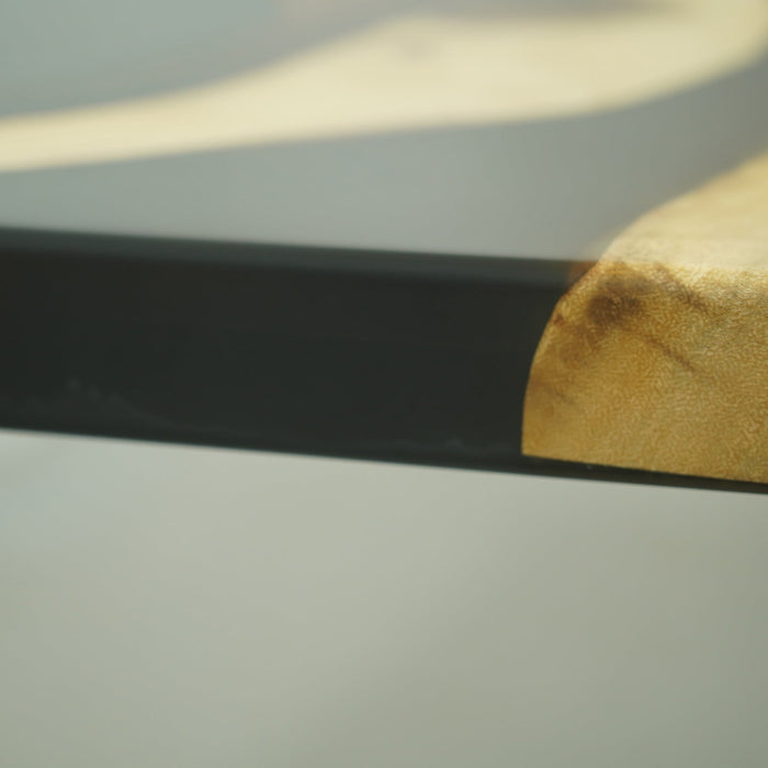 Elegant dining table combining walnut and epoxy.