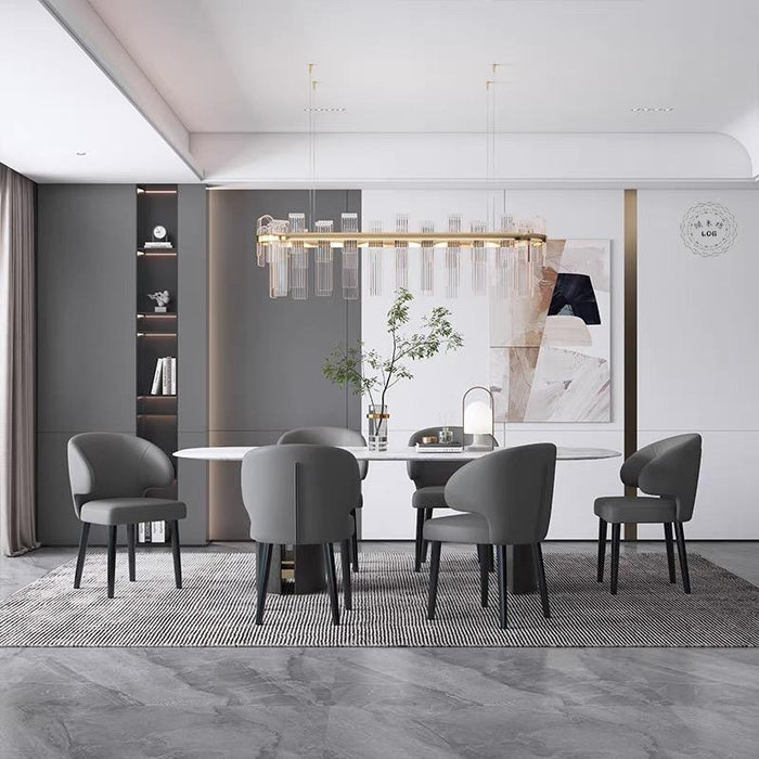 Modern dining room with gray chairs, a white table, and abstract art on the wall.