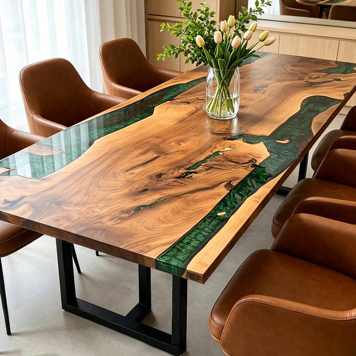 Top-down view of a walnut wood epoxy river table with deep emerald green resin and live-edge grain.