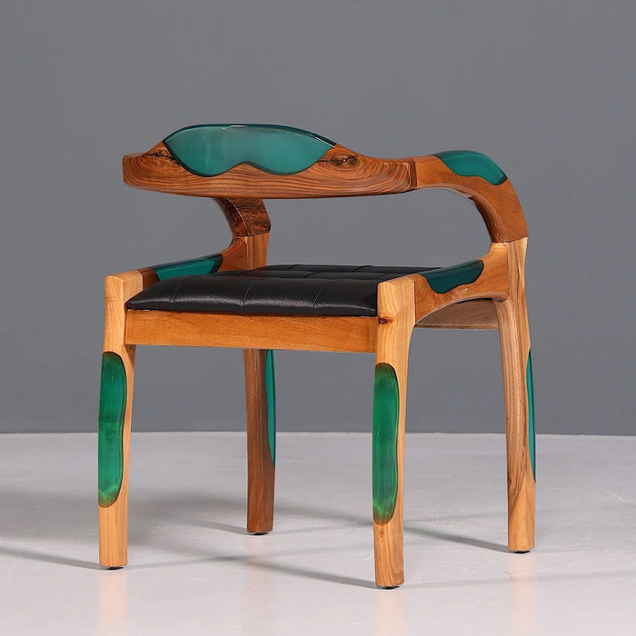 Wooden chair with green accents and black seat on a gray background