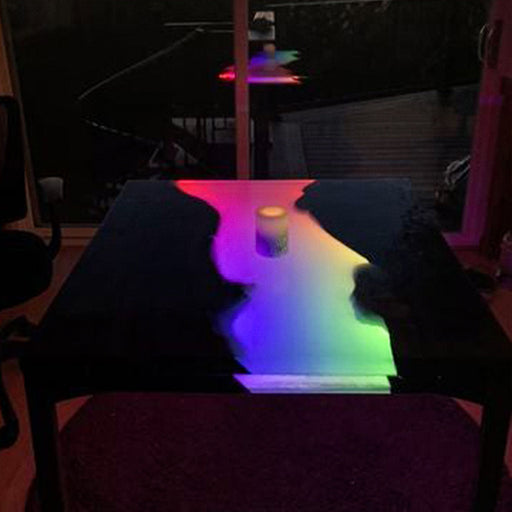 Custom dining table with walnut wood and LED resin river
