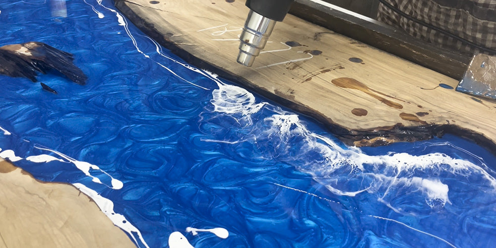 Epoxy resin curing in mold to solidify live edge table structure