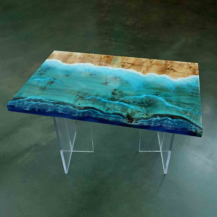 Table with a wooden top and blue resin inlay on a green background