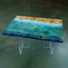 Table with a wooden top and blue resin inlay on a green background