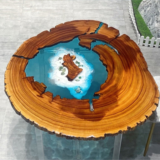 Artistic live edge wood table with embedded epoxy resin ocean scene, showcasing an intricate island landscape for unique and elegant interior decor.
