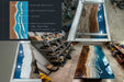 Wooden table with blue resin design in a workshop setting