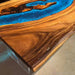Epoxy resin and wood coffee table with California modern style and vibrant blue inlay.