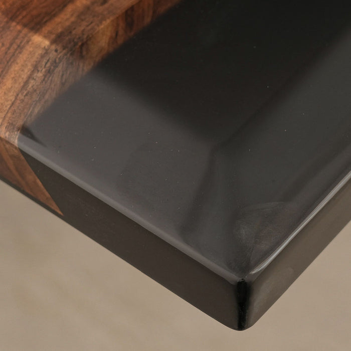 Black rectangular object with wooden edge on a neutral background