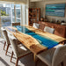Dining room with a wooden table featuring a blue resin inlay, surrounded by chairs.