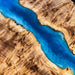 Aerial view of a blue river cutting through a desert landscape