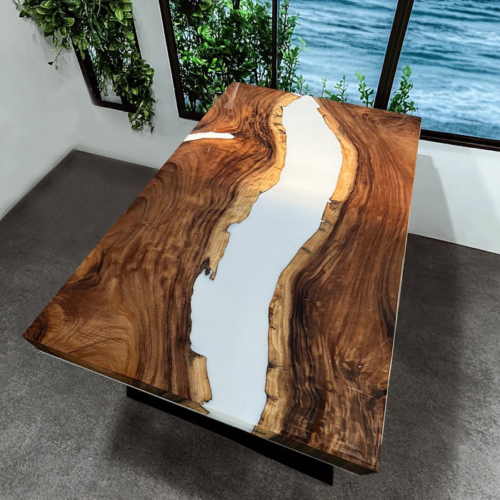 Modern epoxy river table featuring white resin and live edge wood