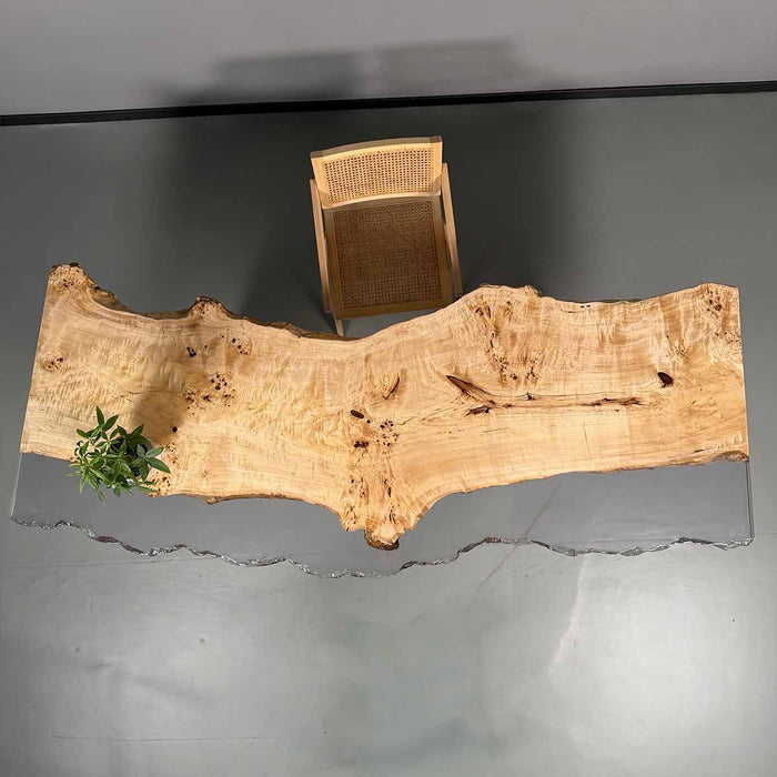 Wooden coffee table with natural finish and wicker side table on a gray background