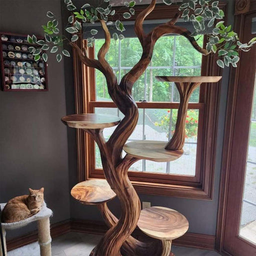 Wooden cat tree with multiple levels and a cat sitting on one of the platforms.