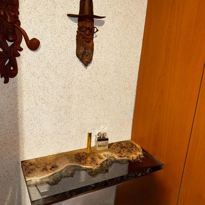 Wooden shelf with decorative items against a wall with a sword mounted.