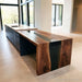 Glossy black resin waterfall table in modern home interior