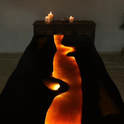 Glowing black wood and resin table with embedded lights for luxury interiors