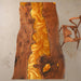 Handcrafted natural walnut table featuring a shimmering gold epoxy resin river design.