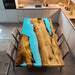 Front view of a 47×80 Golden Camphor light blue epoxy resin dining table, ready to seat 8 people.