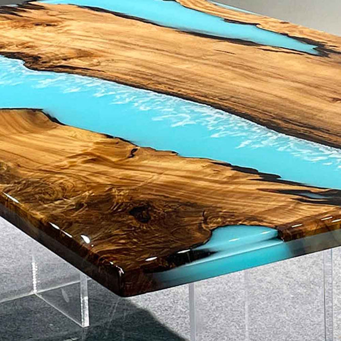 Golden Camphor light blue epoxy resin table paired with minimalist chairs and modern decor.