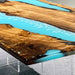 Golden Camphor light blue epoxy resin table paired with minimalist chairs and modern decor.